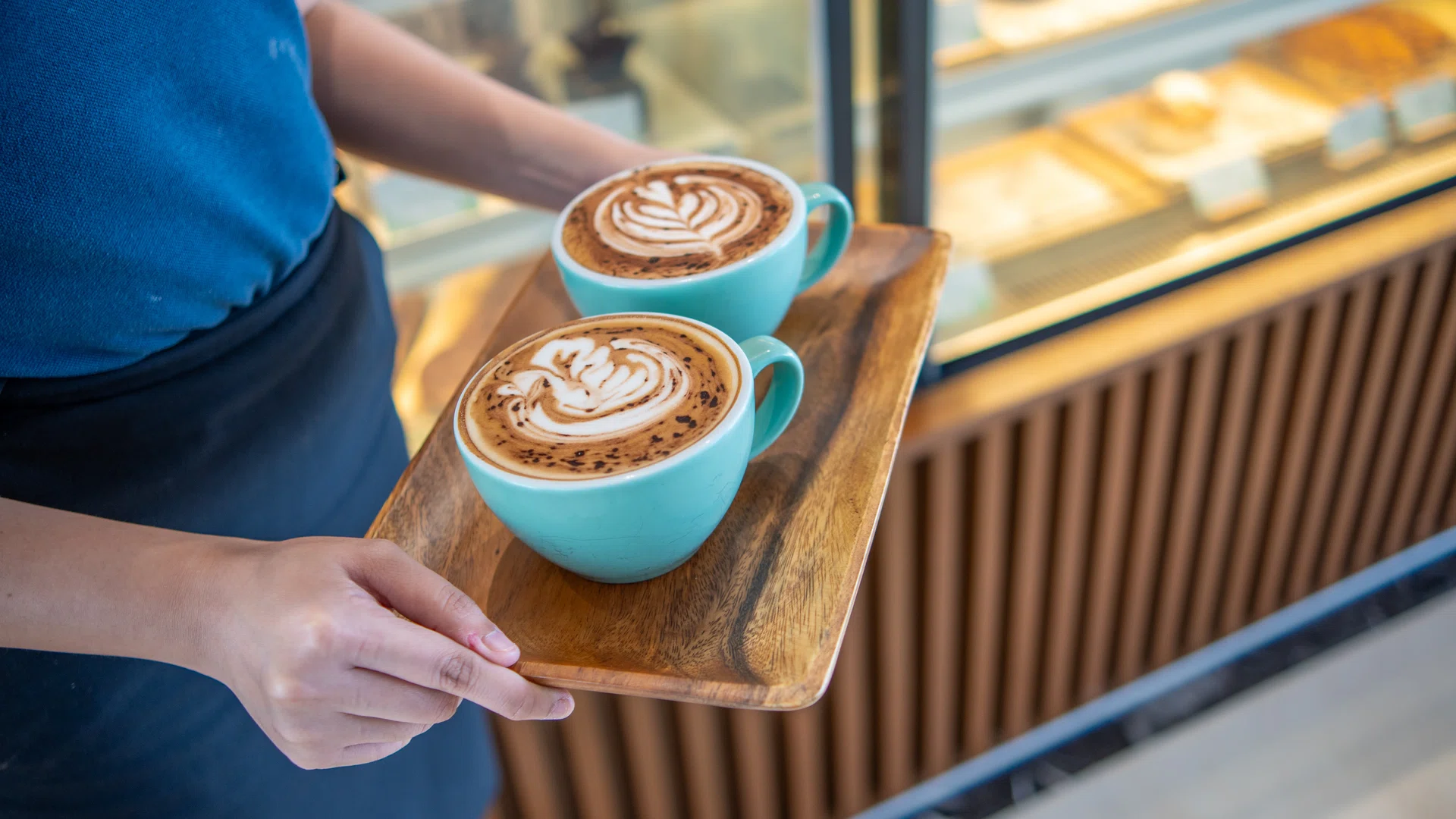 Barista Serving Latte Art Coffee