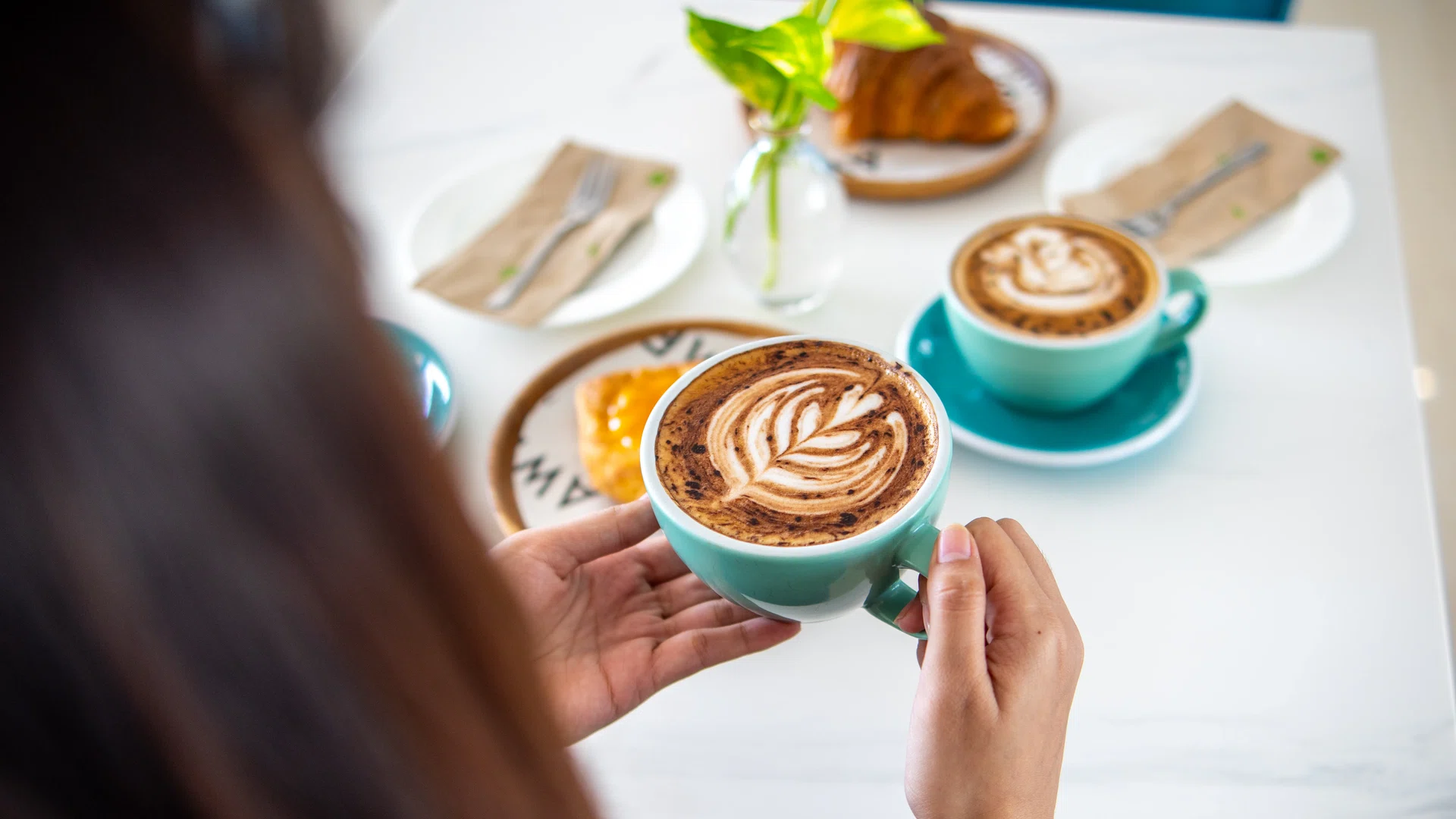 Guest enjoying latte art in the lobby cafe